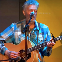 Jonathan Ochshorn playing guitar in Cortland, NY